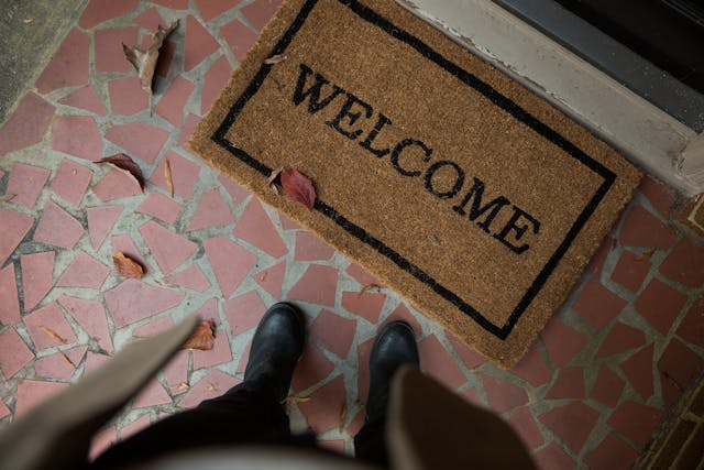 Person standing infront of a welcome mat